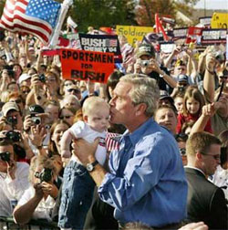 US President Bush kissing a baby on the 2004 campaign